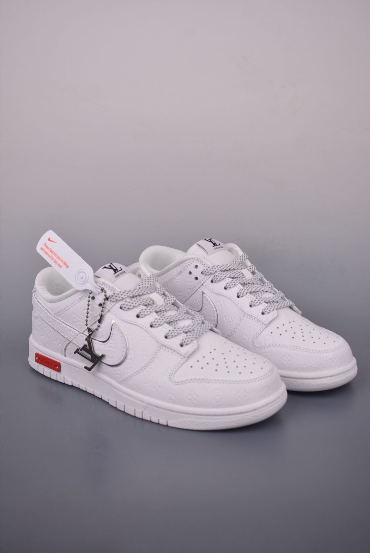 <h4 style="text-align: center;"><strong>These appear to be a custom or conceptual pair of <span class="iNqyIf">Nike x Louis Vuitton Dunk Low<!--TgQPHd|||[]--></span> sneakers in white, featuring debossed monogram patterns and a distinctive layered Swoosh design.</strong></h4>