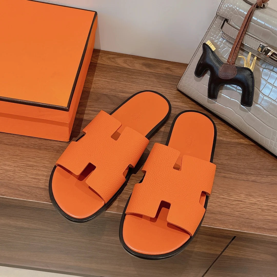 Effortless luxury meets everyday comfort. The Hermès Slipper in vibrant orange delivers iconic French craftsmanship with a relaxed silhouette perfect for home or street styling. Premium materials a...