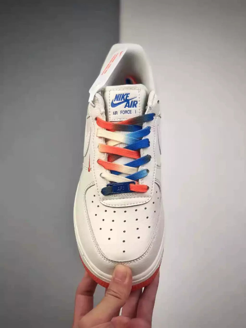 <h4 style="text-align: center;"><strong>The shoe shown in the image appears to be a white Nike Air Force 1 Low, featuring laces with a distinctive color gradient.</strong></h4>