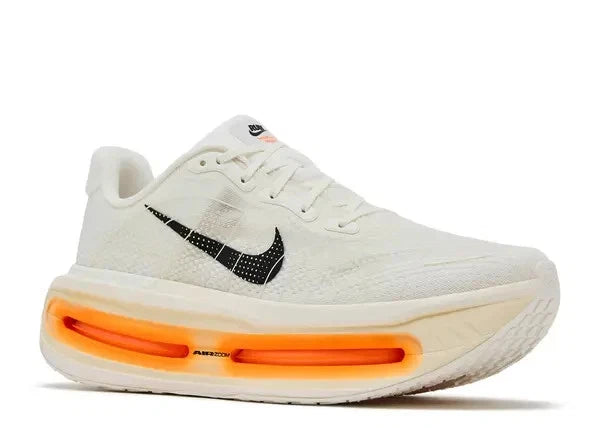 This appears to be a pair of Nike Vomero Premium road running shoes in the sail, coconut milk, and total orange colorway, featuring a thick stacked sole with visible Air Zoom cushioning.