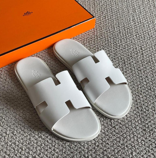 Elevate your casual comfort with the Hermes Slipper in crisp white. Designed for premium everyday wear, this luxe slipper combines soft materials with refined minimalist aesthetics. Perfect for lou...