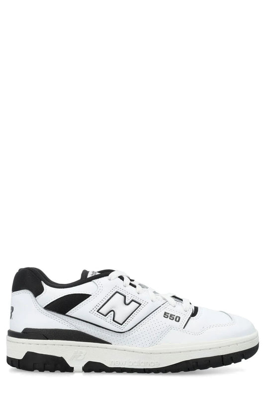 This appears to be a pair of New Balance 550 White Black sneakers featuring a classic low-top leather upper with contrasting black accents and the signature "N" logo on the side.