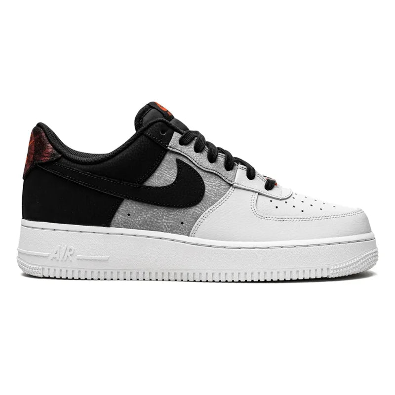 <h4 style="text-align: center;">The image shows a Nike Air Force 1 '07 LV8 sneaker in shades of black, Smoke Grey, and white, with red details at the heel.</h4>